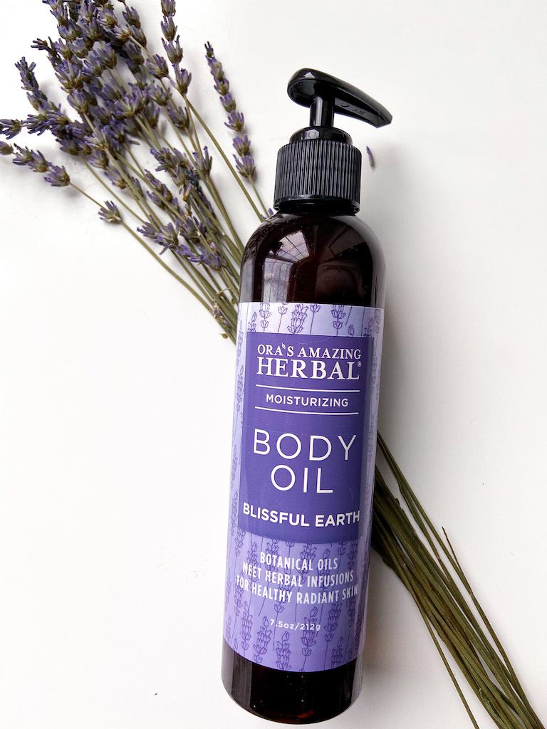 Ora's Amazing Herbal lavender body oil with a bunch of fresh lavender.