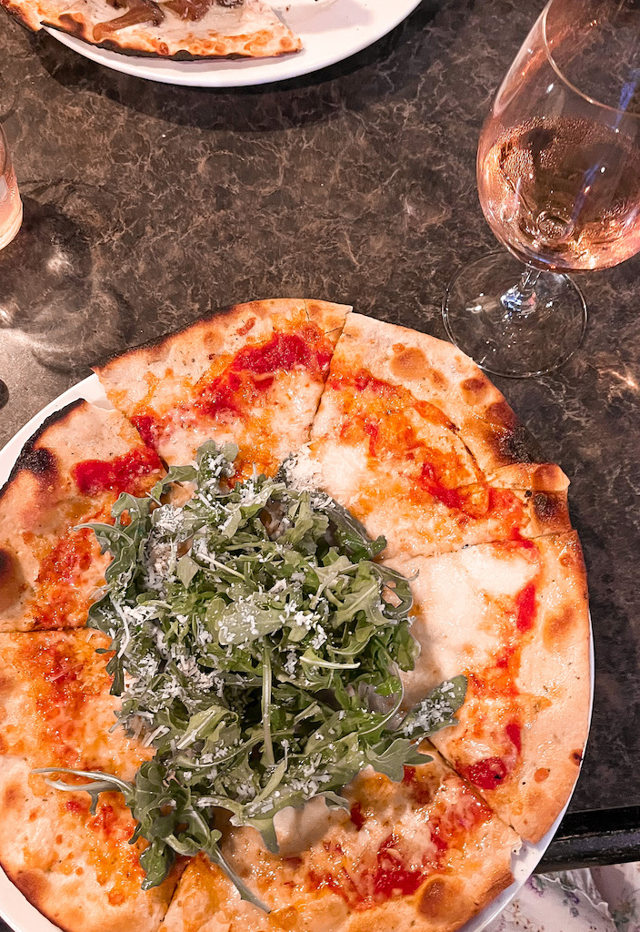 Image description: a pizza and glass of wine from The Old Winery in Niagara-on-the-Lake.